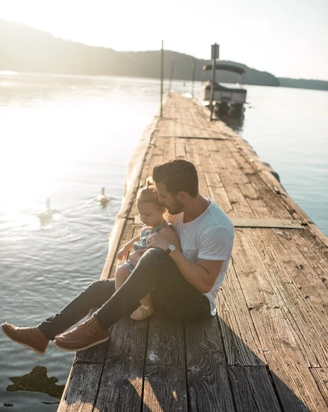 A family sitting together on a pier
