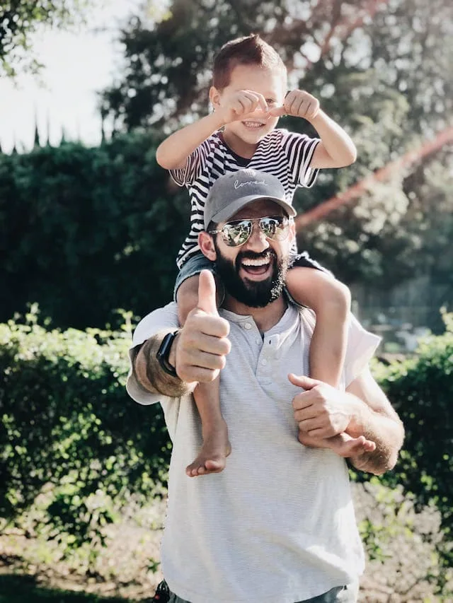 A father carrying his son on his shoulders